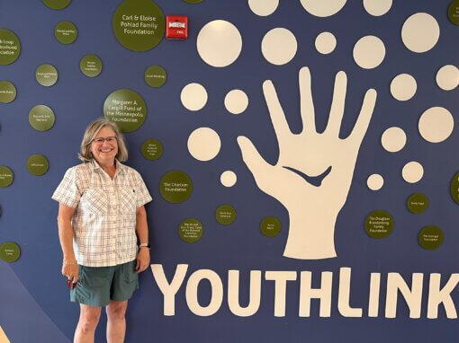 Meredith standing in front of YouthLink sign
